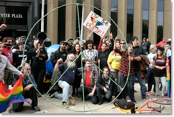 May Day 2012, San Diego, California. -- Occupiers rush forward to defend the earth (see the blue globe in the back) in the grand finale of the particpatory theater performance. Photo by Nic Paget-Clarke.