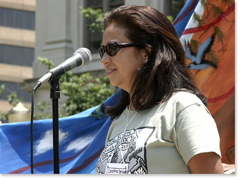 Carolina Delgado of Jobs With Justice was one of the Spanish-language MC/interpreters at the rally before the downtown march. All USSF materials were in Spanish and English. Many events were in English, Spanish, and also interpreted into sign language.