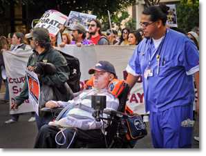 Raúl Carranza, accompanied by nurse Sam Uybungco   joins in leading the Human Rights March for Labor/Occupy SD through downtown San Diego. Photo by Johnny Nguyen.