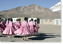 Dancing during a religious festival in the small mountain community of Sajama, by the snow-covered Mount Sajama.