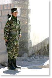 A soldier on guard an entrance to a military zone near the border.