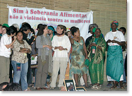 Via Campesina members with a banner in support of food sovereignty and an end to violence against women.
