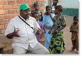 As children look on, Julio dos Santos Pessego speaks to association members after a meeting in Lusanyando, near Lichinga.