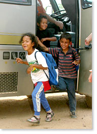 Children arrive back at the settlement.