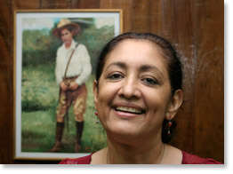 Alba Palacios. She is a deputy for the Sandinista Front and Second Secretary in the Nicaraguan National Assembly. She is a former leader of the ATC. Here she is in her office. The portrait on the wall is of Augusto Sandino.