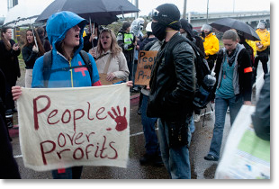 "People over profits" at Occupy event. Photo by Ben Cossel.
