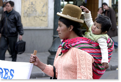 During a march/dancing through downtown La Paz, Bolivia, people from different communities support women's and children's rights to education, to read, to write, to overcome poverty.  Photo by Nic Paget-Clarke. 