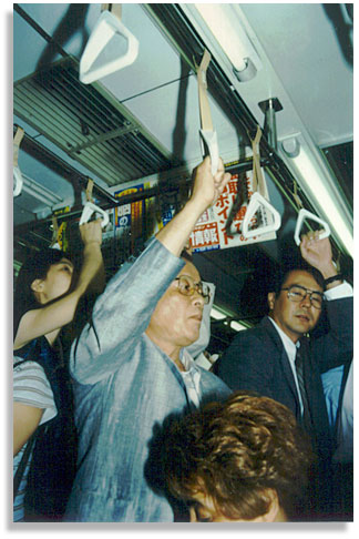 Commuter. On the Ginza Line in Tokyo, Japan. August 2000. Photo by Amelia Li.