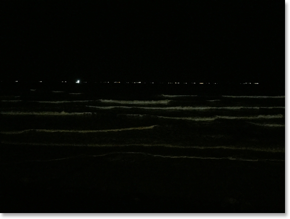 In the dark. A portion of a line of ships wait for permission to enter the Houston Ship Channel. View from the Galveston sea wall. Texas. Photo by Nic Paget-Clarke.
