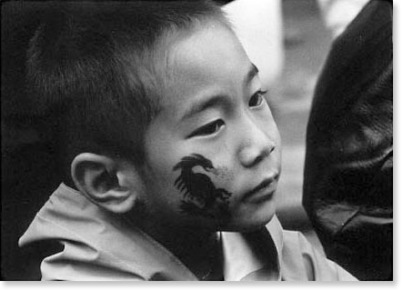 A young Chinese boy at the street festival in San Francisco Chinatown. Photo by Bruce Takeo Akizuki.
