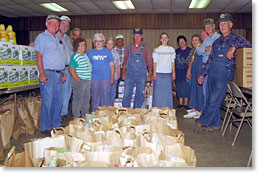 Food Co-op members gather around some bags ready to go.